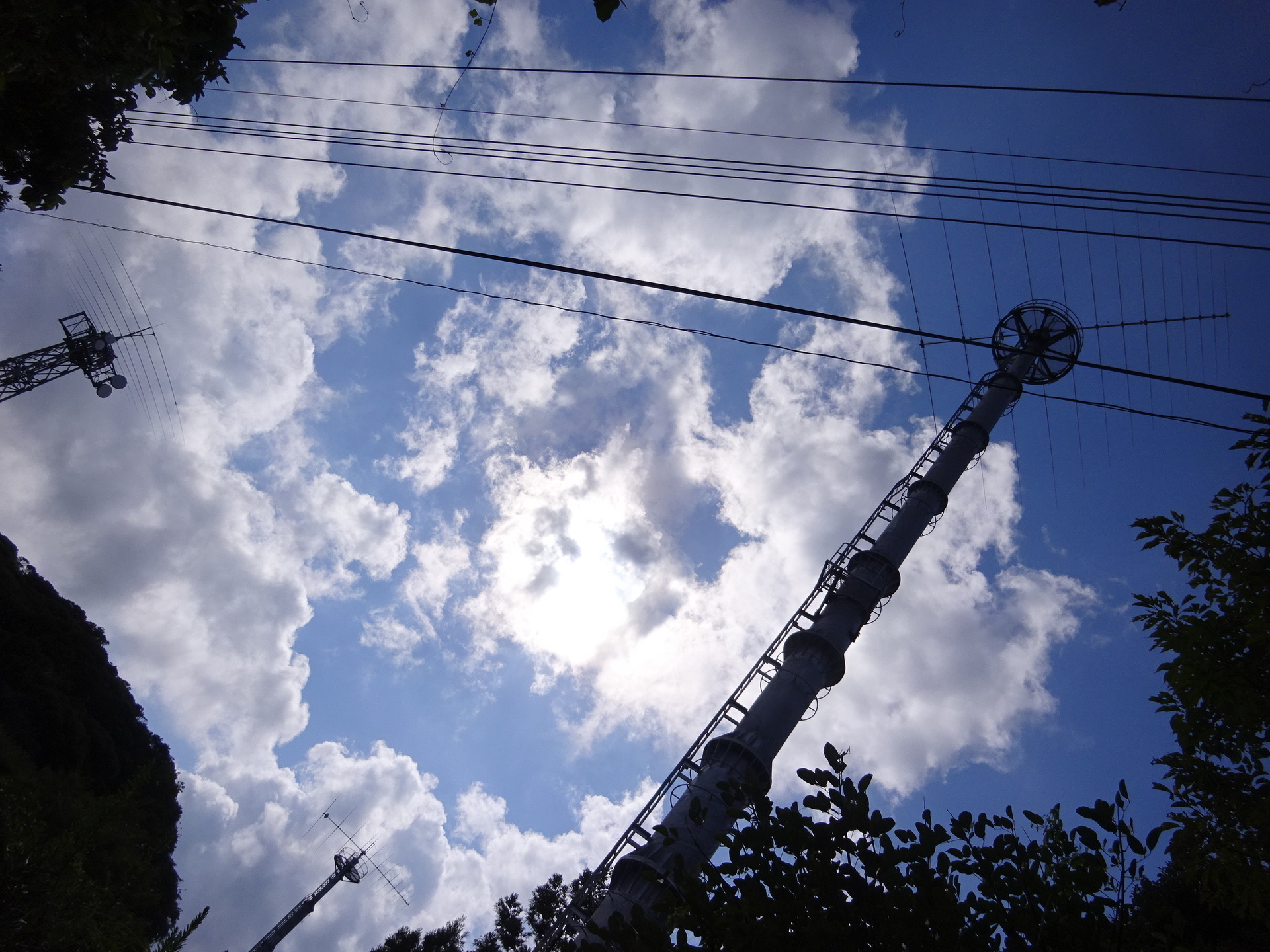 All three transmit towers on the ridge: Johor-facing lattice mast on the left, with the London and Chicago monopoles to its right.