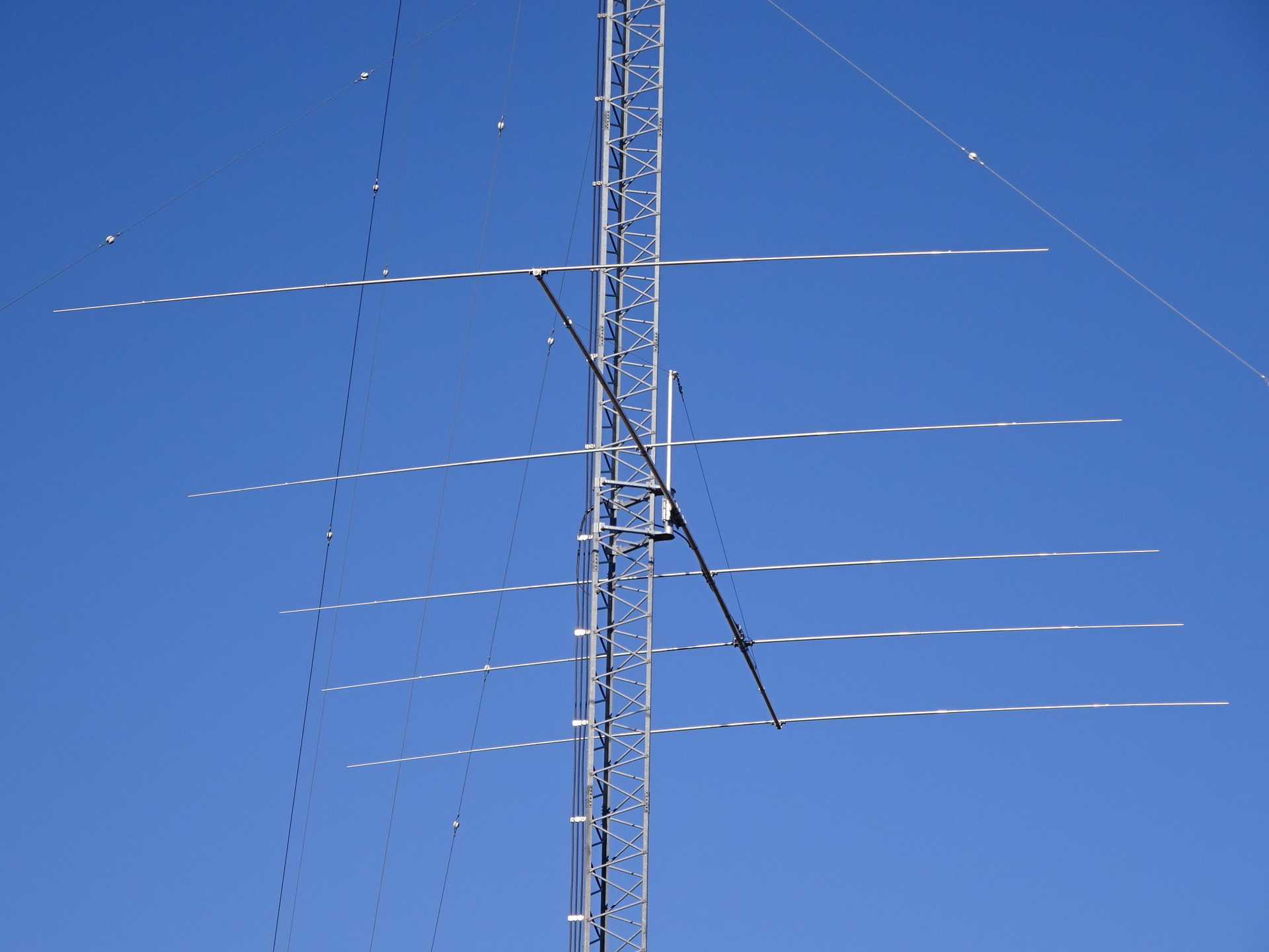 The added five-element Yagi on the taller east tower points toward the Philippines. Its fed element is second from the back; the three directors point toward the camera.